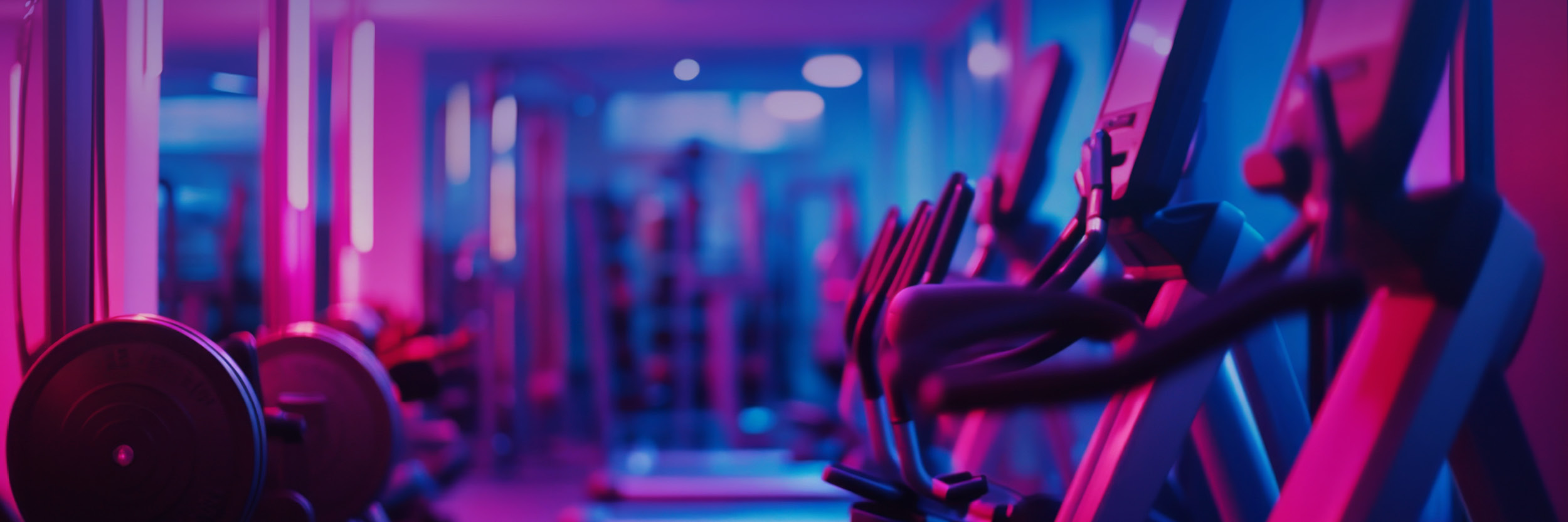 line of treadmills with a purple hue