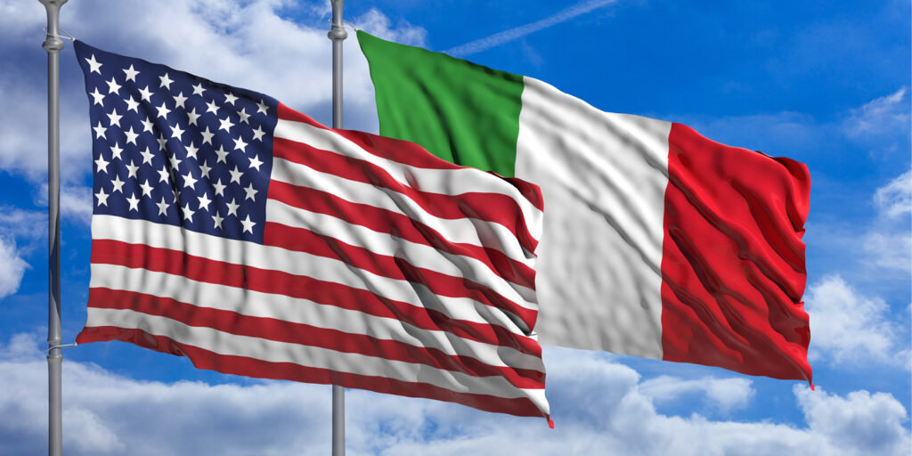 United States flag and Italian flag side by side in the sky, symbolizing global collaboration and Italian advisory practice for international business support.